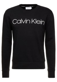 Černá bavlněná mikina s dlouhými rukávy, s kulatým výstřihem a bílým logem "Calvin Klein" vytištěným na přední straně.
