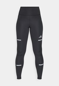 Leggings neri con vita alta, realizzati in materiale liscio. Presentano strisce riflettenti bianche vicino alle ginocchia e un logo Adidas.