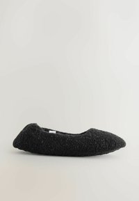 Black felt ballet flat with a pointed toe, textured upper, and a rubber sole. Features minimal stitching and a small label visible on the side.