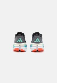 Muške Adidas tenisice za trčanje imaju sivi gornji dio, tirkizne detalje, debeli bijeli srednji potplat i narančasti gumeni potplat s teksturiranim uzorkom.