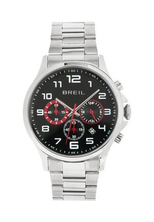 Sølvrustfrit stål ur med en sort skive, hvide time-markører og røde accenter. Har tre sub-dialer og et datovindue.