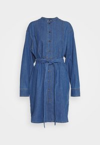 Denim shirt dress in dark blue, featuring a collar, button front, long sleeves, and a tie belt at the waist. Distinctive seam detailing.