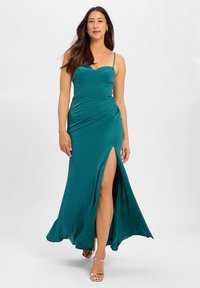 Teal satin maxi dress with a sweetheart neckline, ruched design, and a high thigh slit. Features thin straps and a flowing hemline.