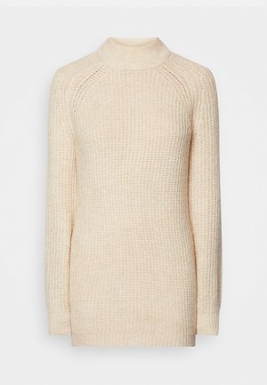 Cream-colored knitted sweater with a high neck, long raglan sleeves, and a textured pattern. Features ribbed cuffs and hem.