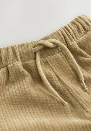 Light beige, ribbed fabric joggers with an elastic waistband and a drawstring. Textured surface with subtle color variations.