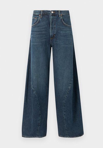 Jean denim bleu foncé à jambes larges avec poches avant, passants pour ceinture et fermeture à bouton à la taille, présenté sur un fond uni.