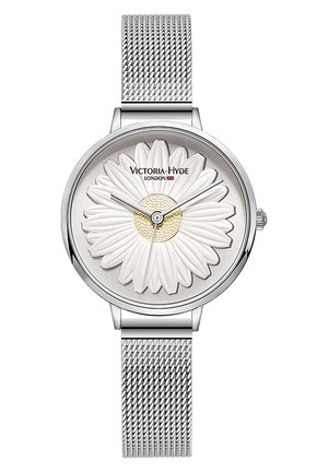 Armbanduhr mit silbernem Netzarmband, weißem Gänseblümchen-Motiv auf dem Zifferblatt und silbernen Zeigern, die die Zeit anzeigen.