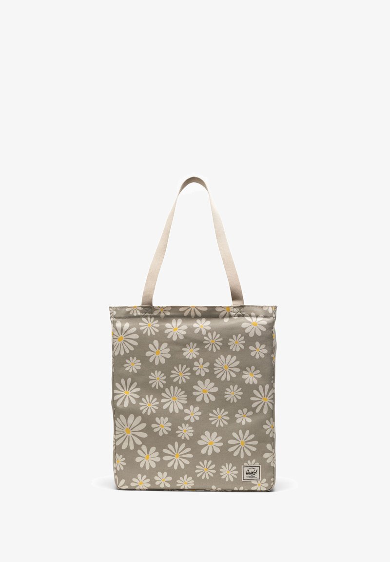 Bolsa de lona con fondo gris, que presenta un patrón de margaritas blancas con centros amarillos y asas de tela beige. Incluye una etiqueta de marca.
