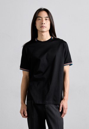 Zwarte T-shirt met korte mouwen, voorzien van contrasterende, kleurrijke gestreepte accenten bij de kraag en mouwen, gemaakt van een gladde stof. Eenvoudige, relaxte pasvorm.
