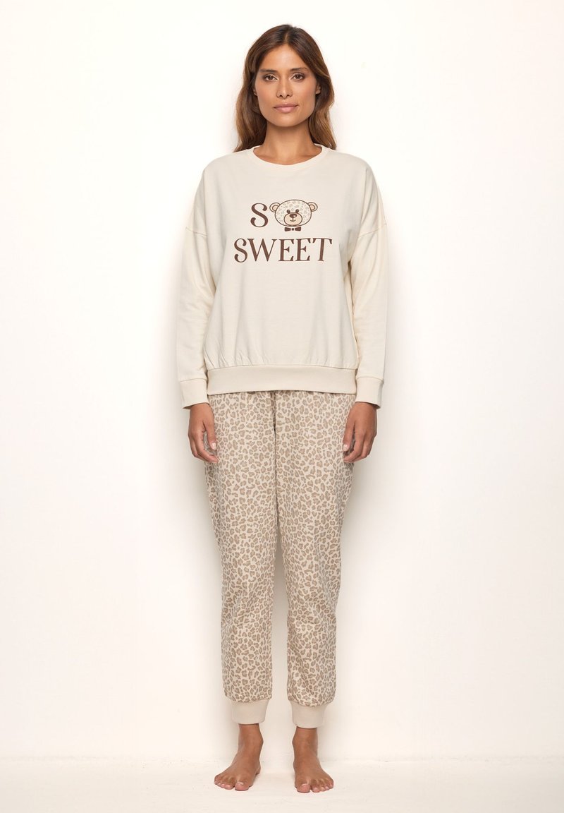 Light beige sweatshirt with "SO SWEET" text and bear graphic, paired with light brown leopard print jogger pants. Soft fabric, relaxed fit.