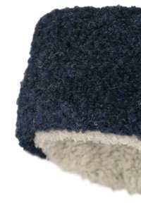 Navy blue hat made of textured yarn with a fuzzy interior in light gray, featuring a thick, cozy band for warmth.