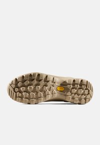 Beżowa podeszwa butów hikingowych z teksturowanej gumy. Posiada wielokierunkowe wypustki dla lepszej przyczepności oraz charakterystyczne żółte logo.