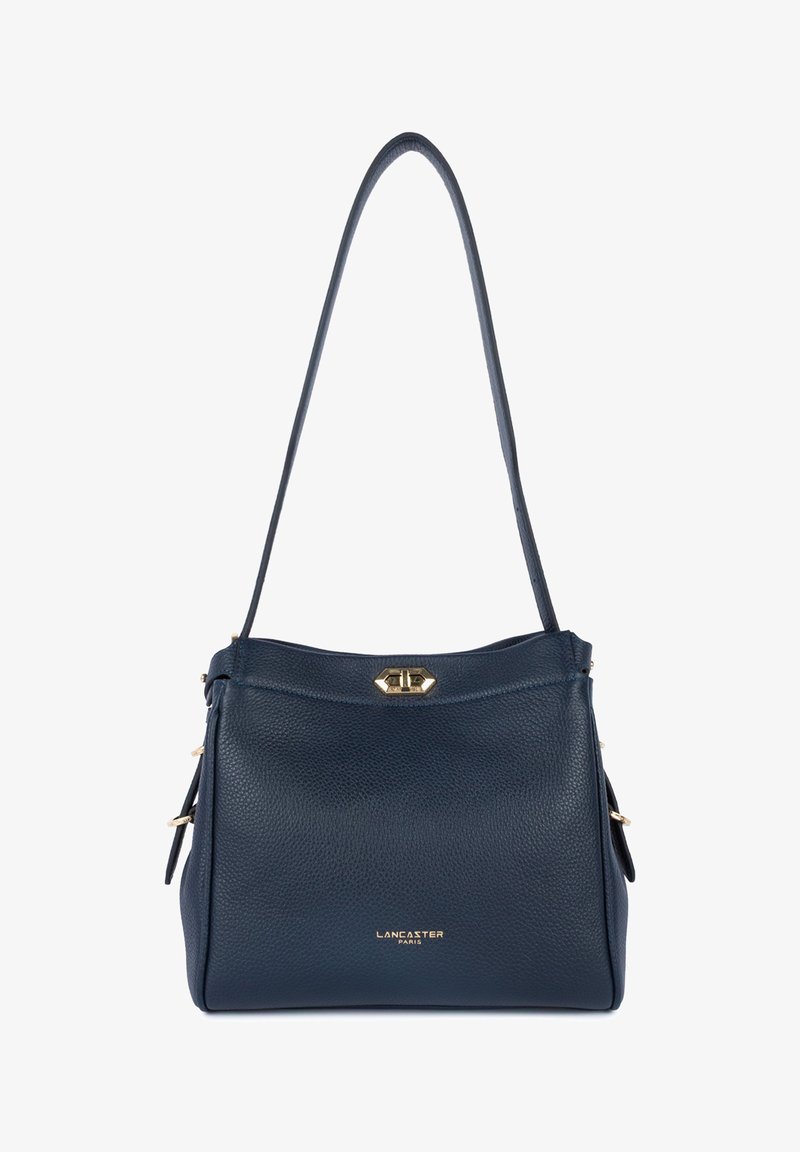 Sac d'épaule en cuir grainé bleu foncé avec une seule bandoulière, fermoir à tour doré et petit logo doré "Lancaster Paris" à la base.