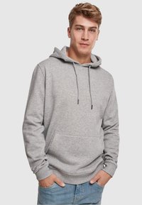 Grå hættejakke lavet af blødt stof, med en kængurulomme, justerbar snøre og ribbede manchetter. Casual design med en afslappet pasform.