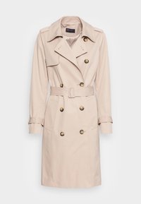 Beige dubbelknäppt trenchcoat med stora knappar, midjebälte, vida slag och knappade ärmslut, gjord av mjukt, lätt tyg.