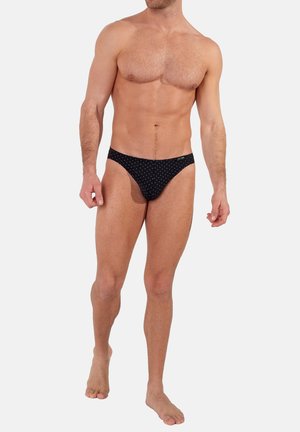 Schwarze Shorts mit weißen Punkten, aus glattem Stoff, im niedrigen Schnitt und mit einem dehnbaren Bündchen für hohen Komfort.