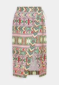 Wrap skirt featuring a vibrant geometric pattern in pink, green, red, and yellow tones, with a side tie and split detail for ease of movement.