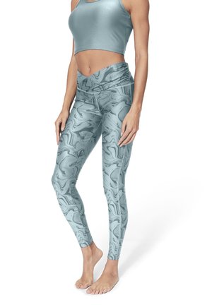 Light blue athletic leggings with a marble pattern, high waistband, and smooth, stretchy fabric. Paired with a matching fitted top.