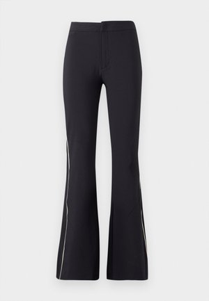 Black flared pants made of stretchy fabric. Features a smooth texture and contrasting white side piping. Simple elastic waistband design.