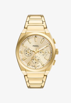 Gold stainless steel watch with a textured gold dial, three sub-dials, and index hour markers. Features a linked bracelet and push-button clasp.