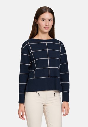 Pull bleu marine au design court, avec des lignes en damier crème sur le devant et un ourlet côtelé. Fabriqué en tissu tricoté doux.
