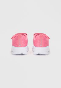 Pink mesh sneakers with a lightweight white sole, featuring back loops and branding detail on the heel.