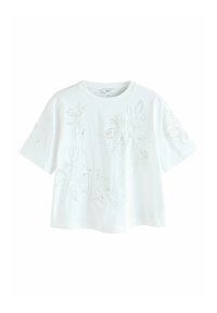 T-shirt blanc à manches courtes avec broderie florale et accents scintillants subtils. Coupe décontractée et texture douce.