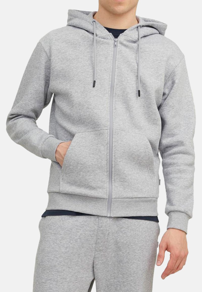 Grå zip-up hoodie i blødt, børstet stof. Har en hætte med snor, kengurulomme og elastiske manchetter. Velegnet til afslappet brug.