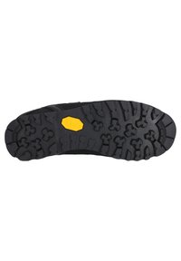 Sort gummisål med et robust slidbane mønster. Har et gult "Vibram" logo inden for en ottekantet form, designet til greb og holdbarhed.