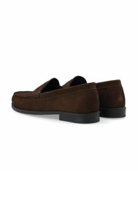 Brown suede loafers with a low black rubber sole, featuring stitched accents and a smooth texture. Angle shows the back view of the shoes.