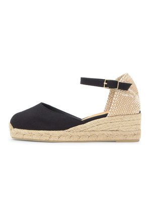 Čierna plátená espadrilová klinová obuv s tkanou jútovou podrážkou, béžovým tkaným opätkom a čiernym členkovým remienkom so zlatou prackou.