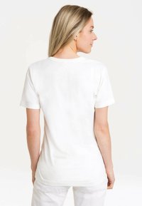 White short-sleeve t-shirt with a crew neckline. Soft cotton material. Plain design, no visible patterns or hardware. Finished edges.