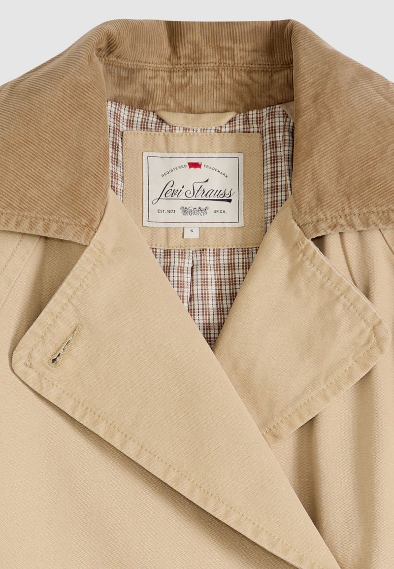 Beige Levi Strauss jacket with corduroy collar and plaid inner lining, size small, showing brand label and stitching details.