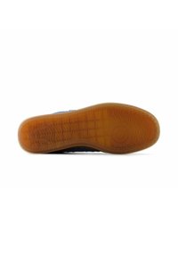 Blue sneaker sole with textured rubber, featuring a patterned grip and a light brown translucent section. Smooth edges and rounded shape.