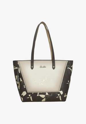 Tragetasche mit einer weißen Vorderseite aus Kunstleder, braunen gemusterten Seiten und zwei braunen Griffen. Mit metallischen Buchstaben und einem dekorativen Anhänger.