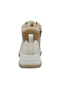 White sneaker with a textured tan corduroy collar, soft fur lining, and a sturdy rubber sole. Features pull tab at the back.