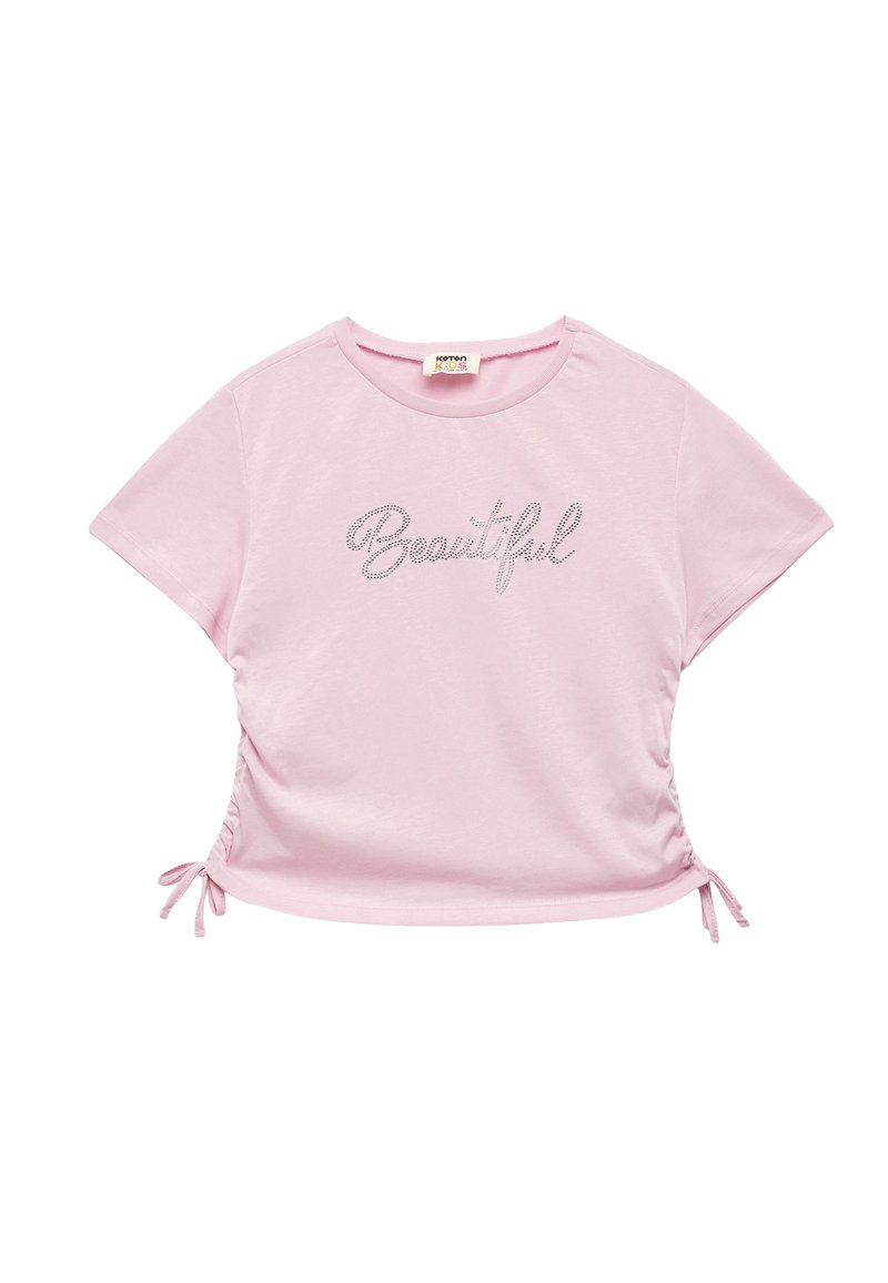 Camiseta de manga corta de color rosa claro, con un diseño fruncido y cordones en los laterales, y el texto metálico "Beautiful" en el frente.