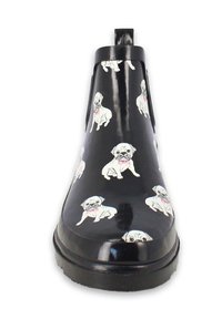 Black rubber ankle boots with a glossy finish featuring a repeating pattern of white pugs with pink collars. Flat sole and pull tab at back.