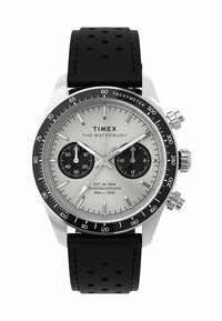 Silver chronograph watch with a black tachymeter bezel, two black sub-dials, and a black perforated leather strap. Text includes "TIMEX THE WATERBURY."