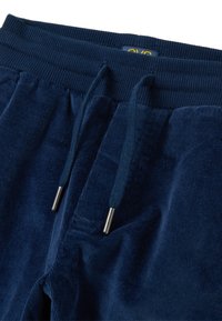 Marineblaue Cordhosen mit geripptem elastischem Bund und passendem Zugband mit Metall-Aglet-Spitzen.