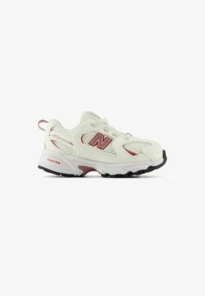 Witte en kastanjebruine New Balance sportschoen met mesh bovenwerk, vetersluiting en dikke gevoerde zool, zijaanzicht op een witte achtergrond.