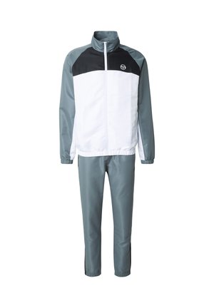 Verryttelypuku, jossa valkoinen yläosa mustilla olkapaneeleilla ja harmaat alaosat. Valmistettu sileästä, kevyestä kankaasta, jossa vetoketjusuljenta.