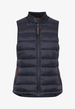 Chaleco acolchado azul marino, sin mangas, con cierre frontal, cuello alto, bolsillos laterales con cremallera y detalles en cuero marrón. Textura acolchada visible.