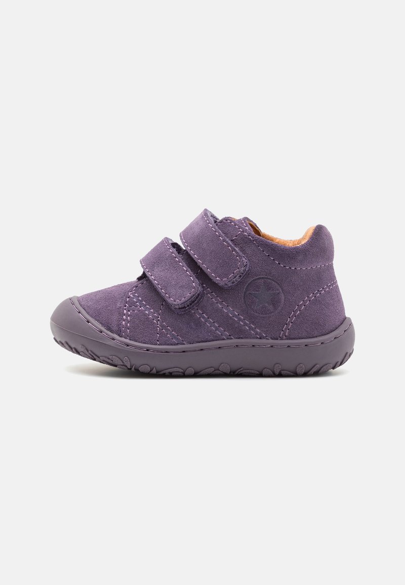 Chaussure violette pour tout-petit avec double fermeture Velcro, semelle texturée et emblème étoile sur le côté, montrée de l'intérieur sur fond blanc.