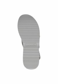 Hall hall kummist jalanõu talla horisontaalsete soonte ja kergelt kaarduva kujuga; küljele on reljeefse "CAPRICE" logoga. Tekstuur on ühtlaselt sile.