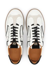 White leather sneakers with a beige suede panel, black laces, and a brown rubber sole. Features a black accent and logo on the tongue.