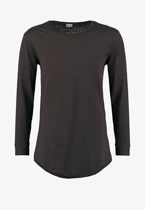 Tumedast puuvillast pikakäiselise, ringsuuruse kaelusega topp. Omab diagonaalset õmblust ja ümarat hemmi, mis loovad moodsa silueti.