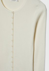 Ribbed white cardigan with a round neckline, featuring a row of six matching buttons down the front and fitted long sleeves.