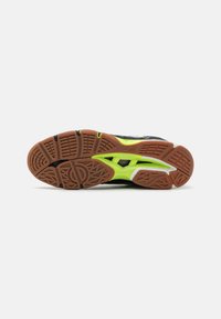 Suela de zapatilla de running negra con tracción de goma, con brillantes acentos amarillos y surcos patrones. Diseño ligero con materiales duraderos.