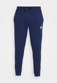 Dunkelblaue Jogginghose mit elastischem Bund und Kordelzug, versehen mit einem weißen Adidas-Logo auf dem linken Oberschenkel. Aus weichem Baumwollmischmaterial.